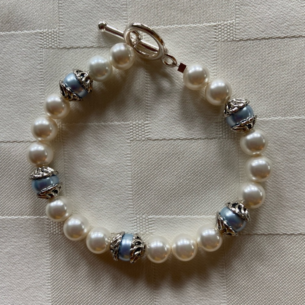 White pearl beads with light blue pearls scattered between. Great for a wedding!